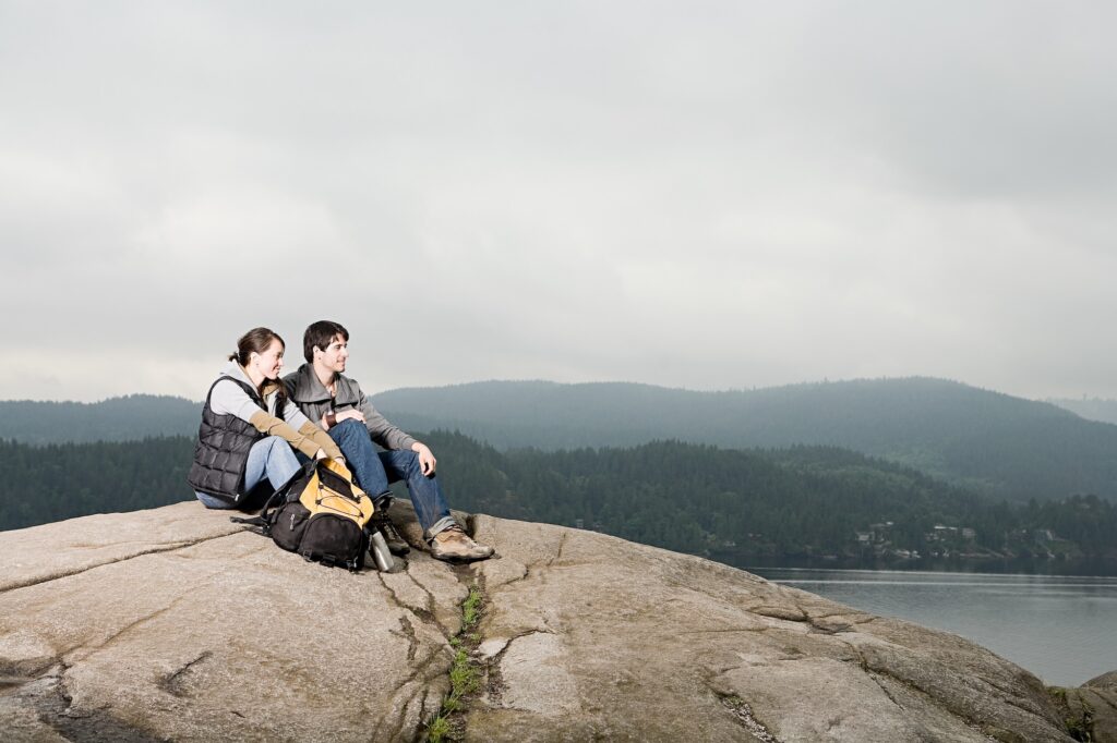 Couple looking out at a mountain lake
